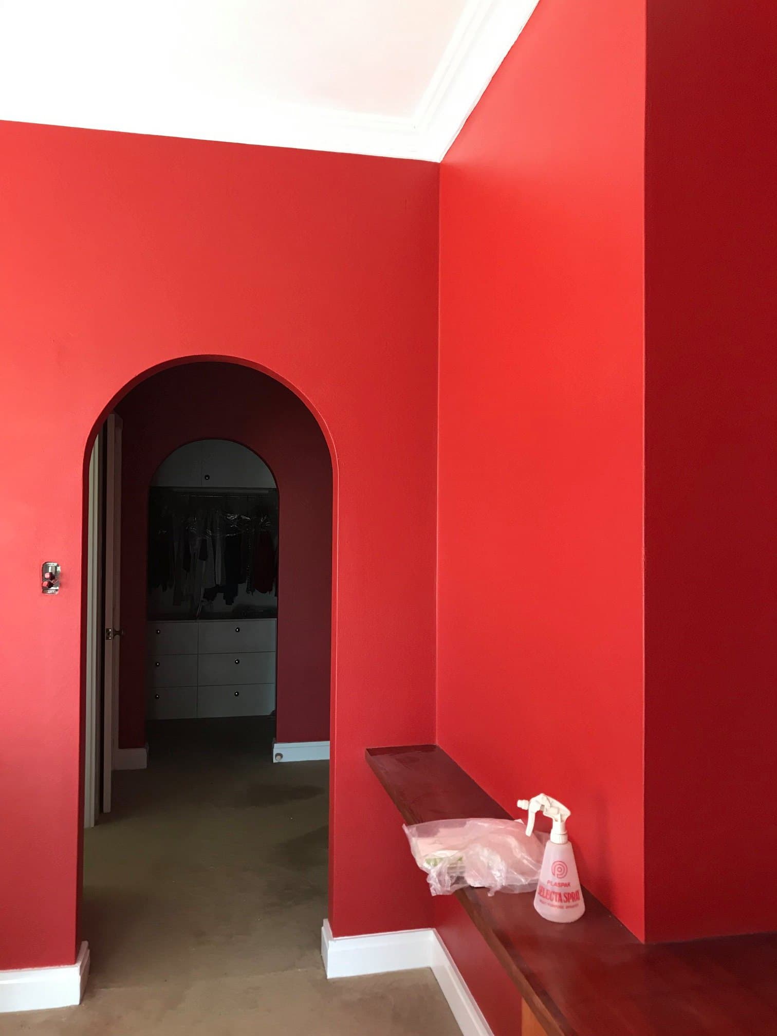 Red hallway archway leading to a walk in robe with white joinery by Murrays Painting, Orange NSW