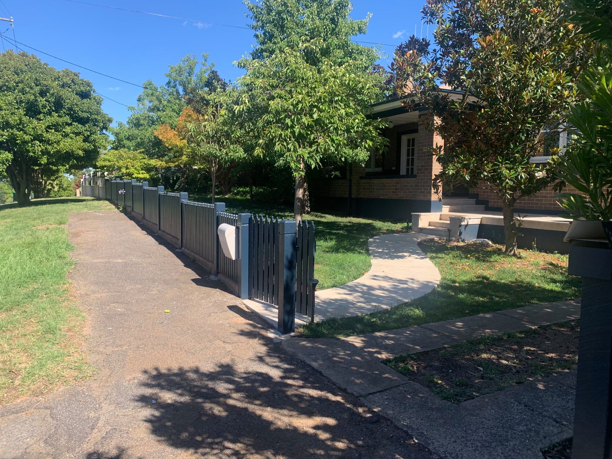 Timber fence stained in a dark charcoal finish by Murrays Painting, Central West NSW