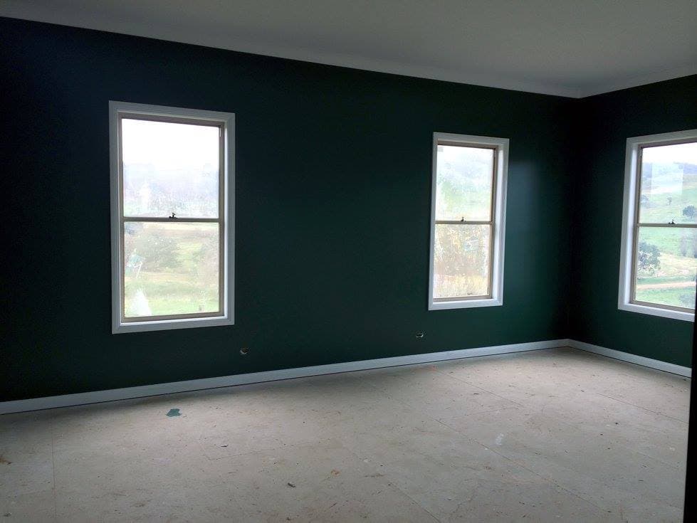 Dark green room with white trim